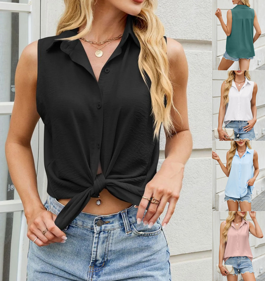 Woman wearing a black sleeveless top with a knot detail and denim shorts, standing in front of a white wall.